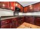 Modern kitchen with dark wood cabinets and granite countertops at 126 Cricklewood Ave, Henderson, NV 89002