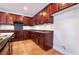 Kitchen corner with dark wood cabinets and granite countertops at 126 Cricklewood Ave, Henderson, NV 89002