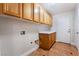 Laundry room with wood cabinets and tile flooring at 126 Cricklewood Ave, Henderson, NV 89002