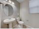 Simple powder room with pedestal sink and neutral color palette at 176 Kimberlite Dr, Henderson, NV 89011