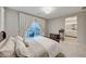 Main bedroom with a comfortable bed, private balcony, and ensuite bathroom at 176 Kimberlite Dr, Henderson, NV 89011