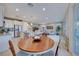 Open concept dining area with round wooden table, adjacent to kitchen at 176 Kimberlite Dr, Henderson, NV 89011