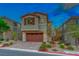 Two-story home with attached garage and landscaped yard at 176 Kimberlite Dr, Henderson, NV 89011