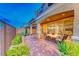Relaxing patio with seating area, brick pavers, and views of the surrounding landscape at 176 Kimberlite Dr, Henderson, NV 89011