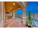 Covered patio with brick pavers, seating area, and mountain views at 176 Kimberlite Dr, Henderson, NV 89011