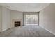 Bright living room featuring a fireplace, soft carpet, and sliding glass doors to a balcony at 2200 S Fort Apache Rd # 2245, Las Vegas, NV 89117