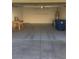 Clean, spacious garage featuring a workbench, shelving, and trash receptacles at 2605 Living Rock St, Las Vegas, NV 89106