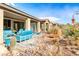 Attractive backyard featuring desert-style landscaping, covered patio with seating, and native plants at 29 Sun Mirage Ave, Henderson, NV 89011