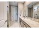 Clean bathroom with tile floors, modern vanity, and a large mirror for ample lighting at 29 Sun Mirage Ave, Henderson, NV 89011