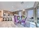 Bright dining area features a glass table, stylish purple chairs, and direct access to the outdoor space at 29 Sun Mirage Ave, Henderson, NV 89011