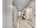 Light and airy hallway featuring wood-look floors, arched doorways, and neutral paint at 29 Sun Mirage Ave, Henderson, NV 89011