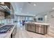 Bright kitchen with stainless steel appliances, island with seating, and open layout into dining and living spaces at 29 Sun Mirage Ave, Henderson, NV 89011