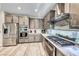 Modern kitchen features stainless steel appliances, integrated oven, and ample cabinet space with stone countertops at 29 Sun Mirage Ave, Henderson, NV 89011