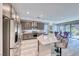 Open concept kitchen seamlessly connects to dining area with stainless steel appliances, a large island, and backyard access at 29 Sun Mirage Ave, Henderson, NV 89011