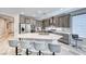 This well-lit kitchen features a central island with bar stools and stainless steel appliances for cooking and dining at 29 Sun Mirage Ave, Henderson, NV 89011