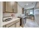 Laundry room with gray cabinets, modern appliances, and plenty of counter space at 29 Sun Mirage Ave, Henderson, NV 89011