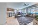 Open concept living room featuring a large sectional, bar seating and backyard access at 29 Sun Mirage Ave, Henderson, NV 89011