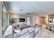 Spacious living room with plush sectional, sliding glass doors to backyard, and modern ceiling fan at 29 Sun Mirage Ave, Henderson, NV 89011