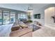Bright living room with large sectional sofa, sliding doors to patio, and backyard views at 29 Sun Mirage Ave, Henderson, NV 89011