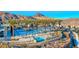 Resort-style swimming pool area with palm trees, comfortable lounge chairs, and stunning mountain views at 29 Sun Mirage Ave, Henderson, NV 89011