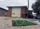 A two-story home with a brick and stucco exterior and a play structure in the yard at 3381 Brussels St, Las Vegas, NV 89169