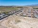 Aerial view of a desert neighborhood with mountain views featuring sidewalks and desert landscaping at 3543 E Wallowa Dr, Pahrump, NV 89061