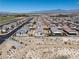 Aerial view of a desert neighborhood with mountain views featuring sidewalks and desert landscaping at 3543 E Wallowa Dr, Pahrump, NV 89061