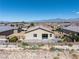 Aerial view of the backyard featuring desert landscape, metal fencing, and a mountain view at 3543 E Wallowa Dr, Pahrump, NV 89061