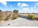 Landscaped backyard featuring a large paved area, planters, and view fencing overlooking the desert at 3543 E Wallowa Dr, Pahrump, NV 89061