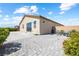 Exterior view of the home showcasing landscaped yard with brick and stamped concrete patios, mature trees, and seating at 3543 E Wallowa Dr, Pahrump, NV 89061