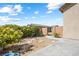 Backyard featuring desert landscaping, shrubs, gravel, stepping stones, and access gate at 3543 E Wallowa Dr, Pahrump, NV 89061