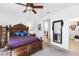 Spacious primary bedroom featuring a dark wood bed frame and a ceiling fan for comfort at 3543 E Wallowa Dr, Pahrump, NV 89061