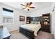 Bright bedroom with ceiling fan, large window and dark wood furniture at 3543 E Wallowa Dr, Pahrump, NV 89061