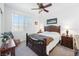 Cozy bedroom with dark wood furniture, plush bedding, and a ceiling fan at 3543 E Wallowa Dr, Pahrump, NV 89061