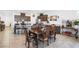 Open-concept dining area and kitchen, featuring dark wood cabinetry, granite counters, and breakfast bar seating at 3543 E Wallowa Dr, Pahrump, NV 89061