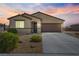 Charming single-story home featuring desert landscaping and a two-car garage at sunset at 3543 E Wallowa Dr, Pahrump, NV 89061