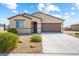 Inviting home featuring a covered entry, complemented by desert landscaping and mature greenery at 3543 E Wallowa Dr, Pahrump, NV 89061