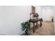 Hallway with beige-tiled floor and decorative table with flowers and greenery at 3543 E Wallowa Dr, Pahrump, NV 89061