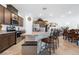 Open kitchen featuring dark wood cabinets, granite countertops, and a breakfast bar at 3543 E Wallowa Dr, Pahrump, NV 89061