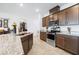 Modern kitchen features granite counters, stainless appliances, and a large island with a sink at 3543 E Wallowa Dr, Pahrump, NV 89061