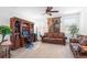 Comfortable living room with neutral carpet, a ceiling fan, and cozy sofas with a wooden desk against the wall at 3543 E Wallowa Dr, Pahrump, NV 89061