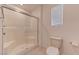 Bathroom includes a toilet and walk-in shower with a glass door and tile walls at 3634 Tripoli Cove Ave, Las Vegas, NV 89106