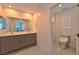 Modern bathroom with double vanity, large mirror, and toilet at 3634 Tripoli Cove Ave, Las Vegas, NV 89106