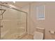 Clean bathroom with a shower, toilet and window with blinds at 3634 Tripoli Cove Ave, Las Vegas, NV 89106