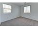 Bright bedroom featuring carpet flooring, white walls, and two windows at 3634 Tripoli Cove Ave, Las Vegas, NV 89106