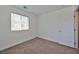 Bright bedroom featuring carpeted floor and large window with blinds at 3634 Tripoli Cove Ave, Las Vegas, NV 89106