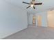 Bright bedroom with a ceiling fan, carpet flooring, and access to a laundry area and ensuite bathroom at 3634 Tripoli Cove Ave, Las Vegas, NV 89106