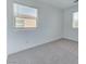 Bright bedroom featuring carpet flooring, white walls, and two windows at 3634 Tripoli Cove Ave, Las Vegas, NV 89106