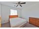Cozy bedroom with ceiling fan, window, and wood dresser at 3634 Tripoli Cove Ave, Las Vegas, NV 89106