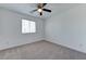Bright bedroom featuring carpet flooring, white walls, and a ceiling fan at 3634 Tripoli Cove Ave, Las Vegas, NV 89106